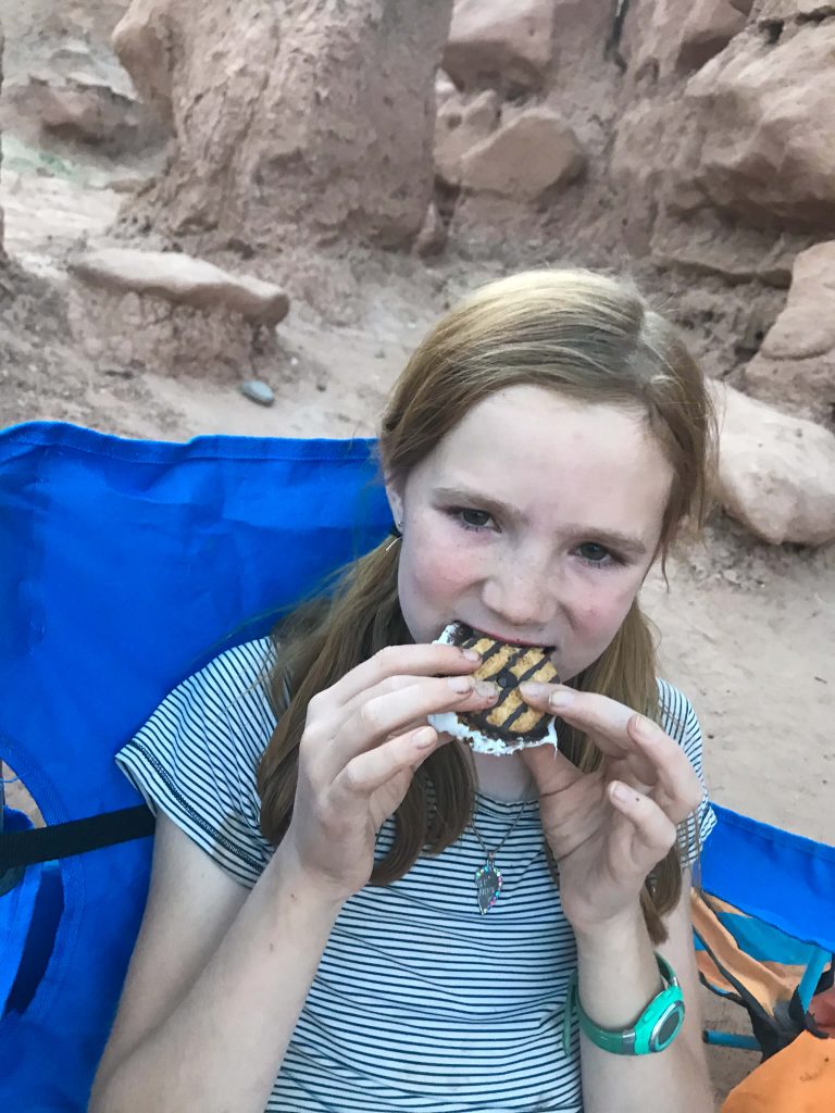 young girl eating smores