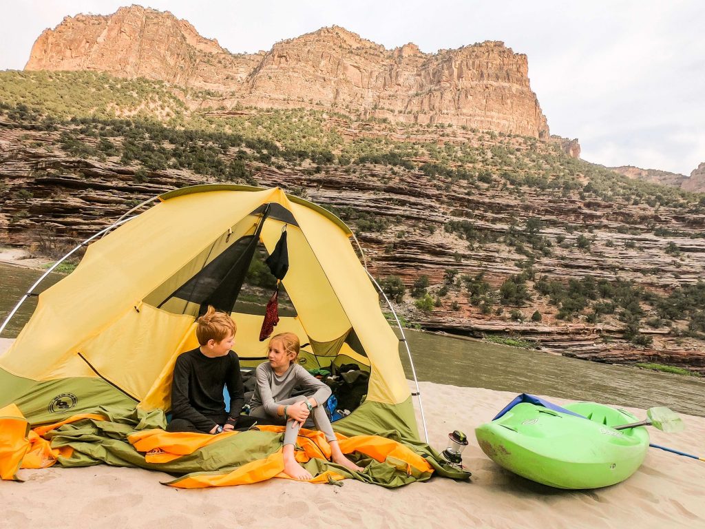 kids together in tent on a river trip