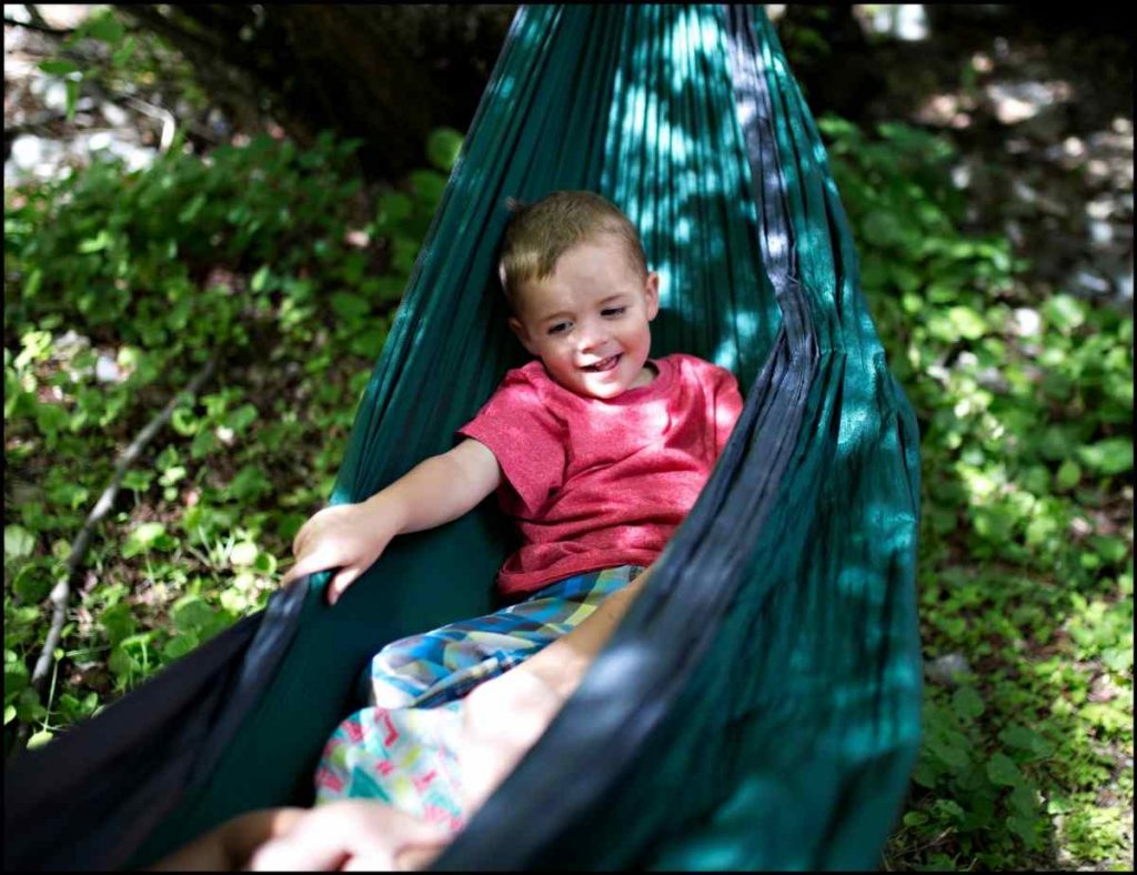 boy playing in hammock