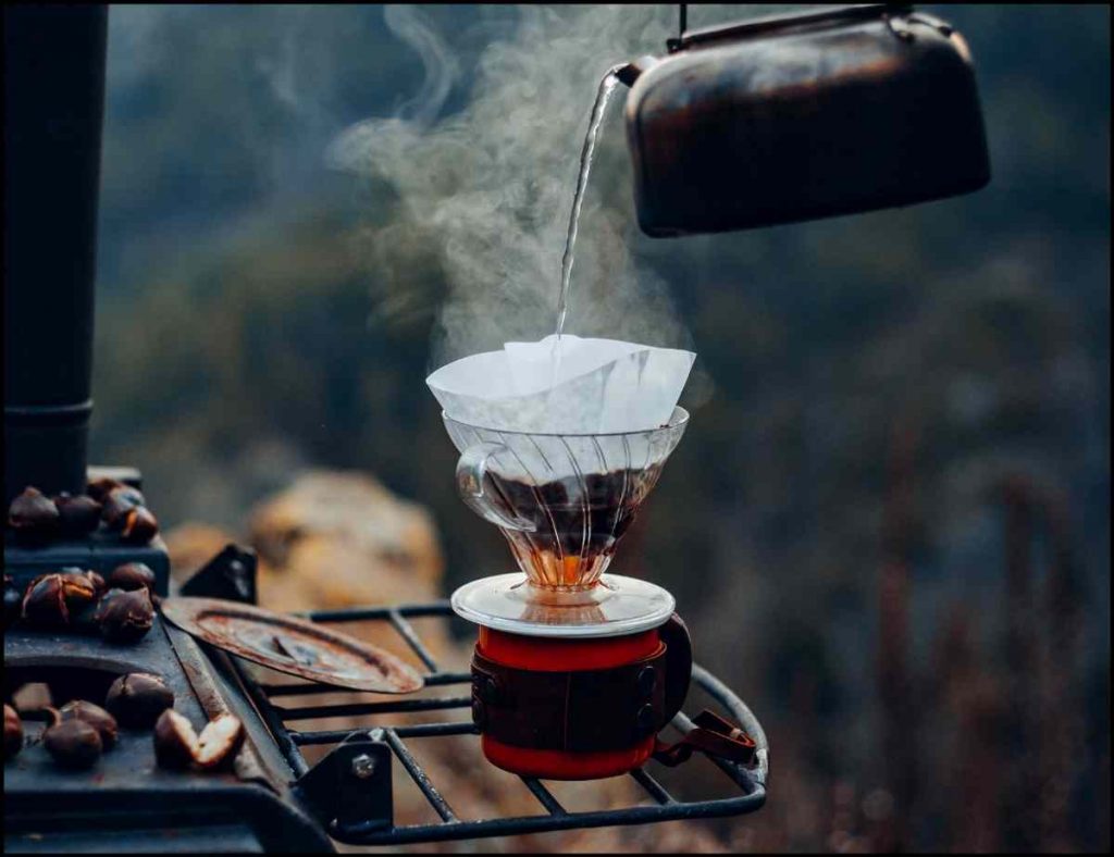 making coffee in a camping mug outside