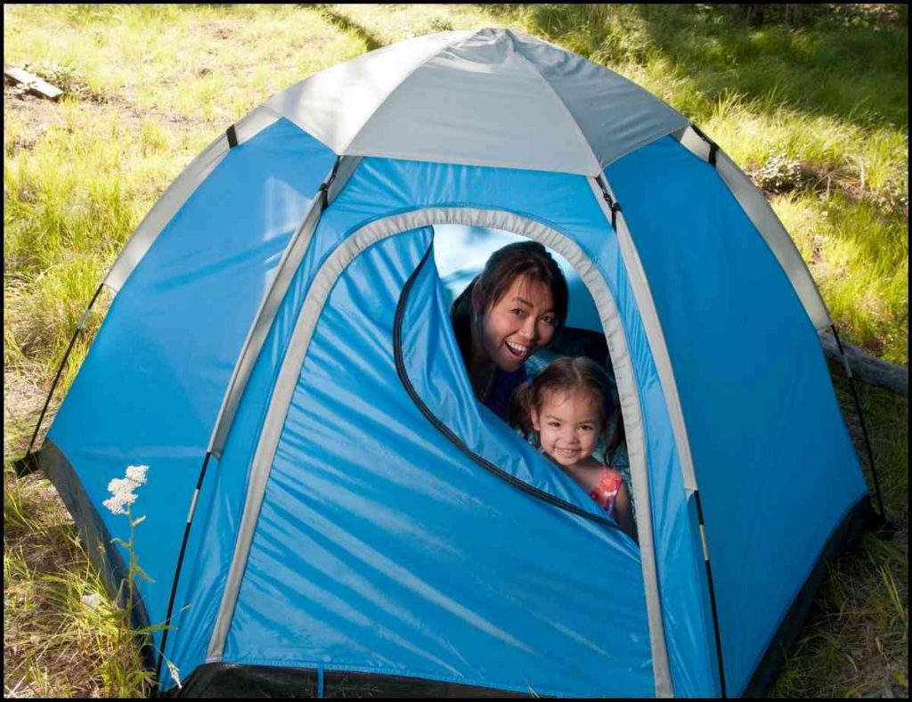 Mother and baby inside a blue baby tent